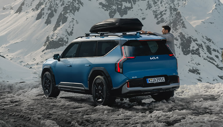 Kia EV9 in den Bergen im Schnee