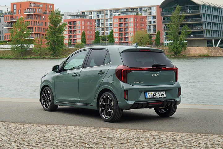 Kia Picanto vor Gewässer und Wohnkomplex