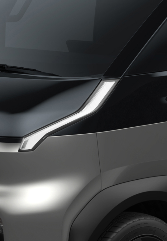 Close-up of the Kia PV5 Cargo front headlight and bonnet design