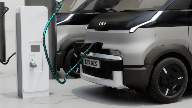 Kia PV5 parked at a public charging station
