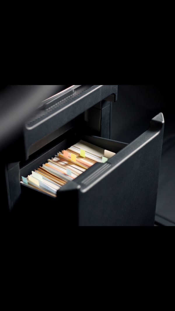 Centre console drawer of the Kia PV5 Cargo with files stored inside