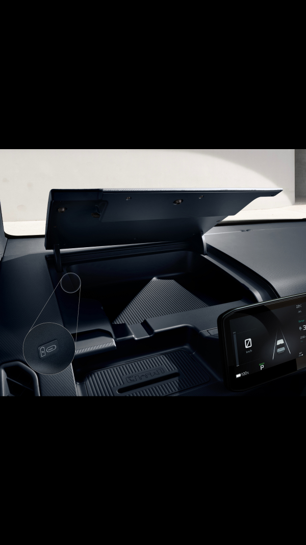 Dashboard storage compartment of the Kia PV5 Cargo being opened