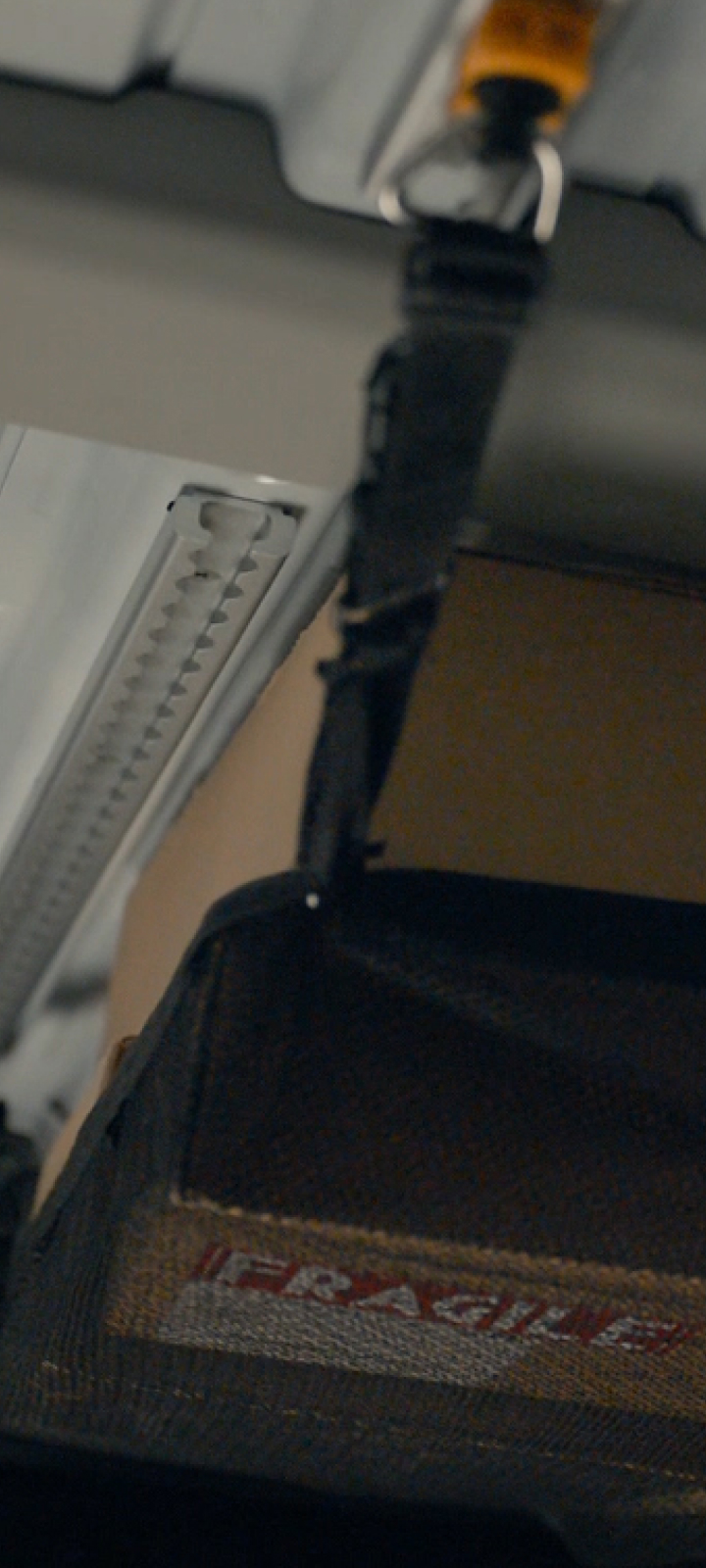 Close-up of Roof-L-Track rail mounted on the KIA PV5 cargo wall