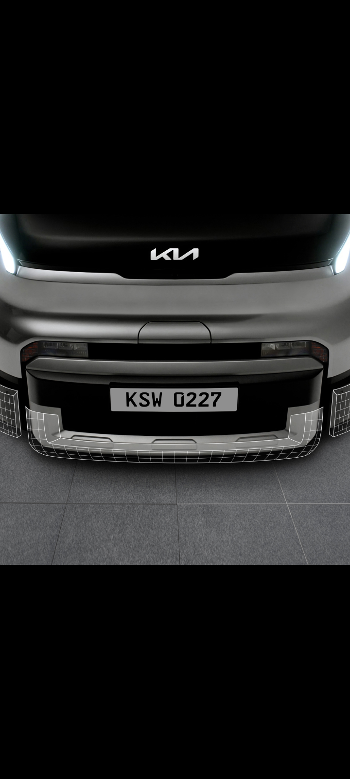 Close-up of the Kia PV5 Cargo front bumper and lower grille