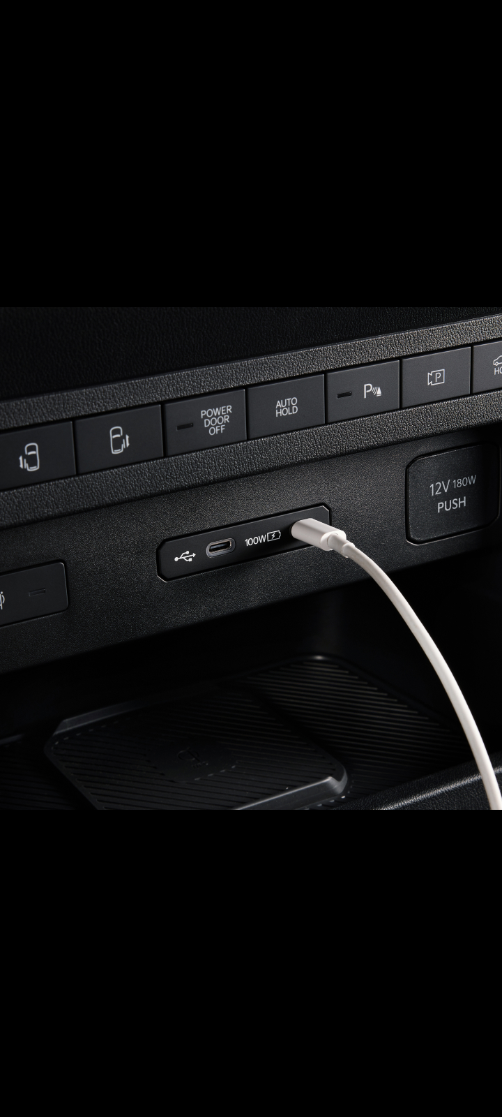 Close-up of the Kia PV5 Cargo dashboard USB port with cable connected