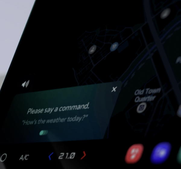Close-up of a Kia PBV IVI showing voice command prompt with navigation map in the background