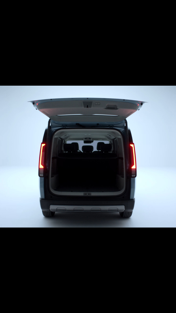 Rear view of the Kia PV5 Passenger with open tailgate revealing cargo space