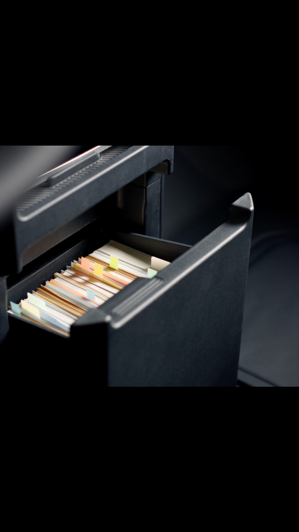 Centre console drawer of the Kia PV5 Passenger with files stored inside