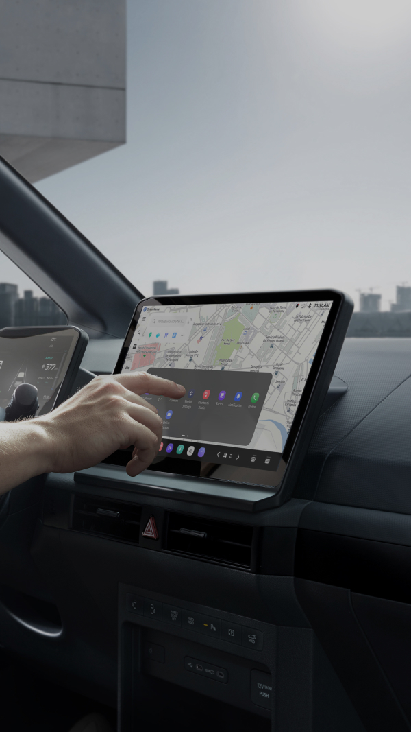 Person interacting with an infotainment touchscreen inside a vehicle