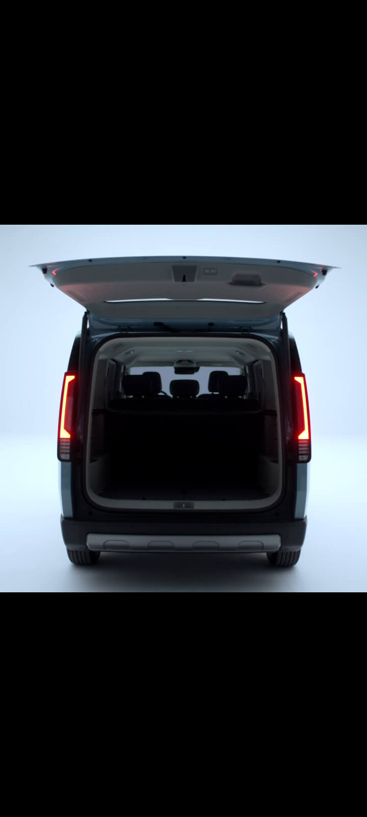 Rear view of the Kia PV5 Passenger with open tailgate revealing cargo space