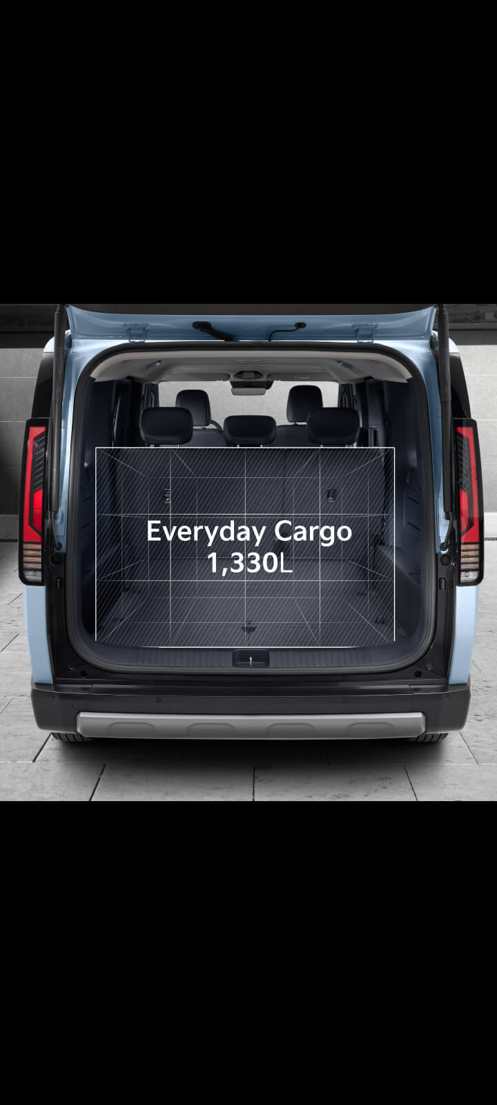 Interior view of the Kia PV5 Passenger cabin showing foldable seatback tray in open position