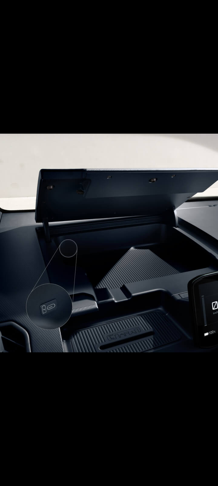 Dashboard storage compartment of the Kia PV5 Passenger being opened