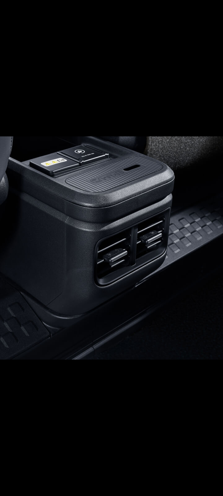 Close-up of the Kia PV5 Passenger rear air vents on the centre console for second-row passengers