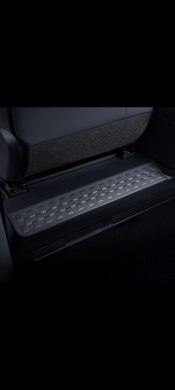 Close-up of the Kia PV5 Passenger integrated footrests beneath rear seats
