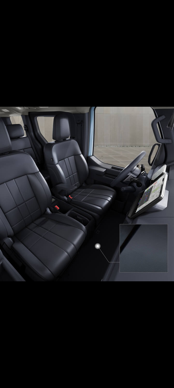 Front cabin view of the Kia PV5 Passenger with durable TPO carpeting across driver and passenger seats