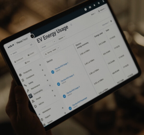 Close-up of a tablet screen showing Kia FMS with vehicle status monitoring