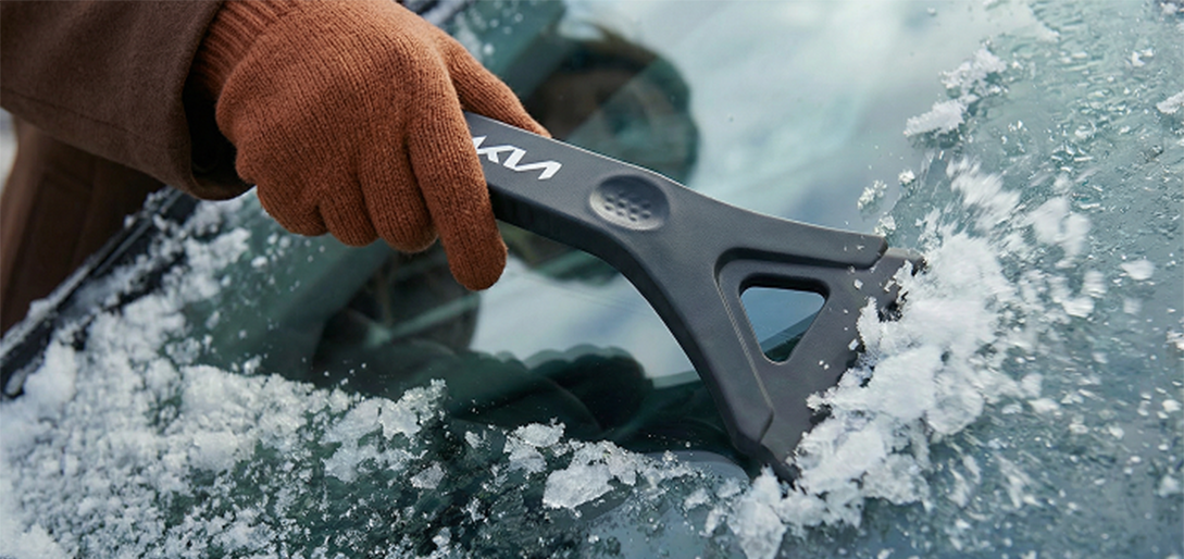 Kia ice scraper on a frosted car window