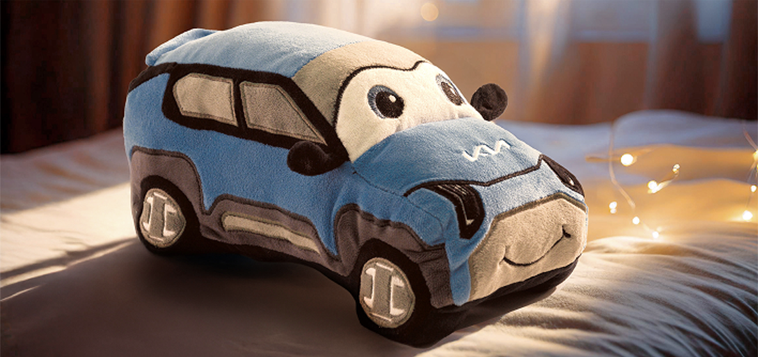 Kia plushie on a blanket next to lights