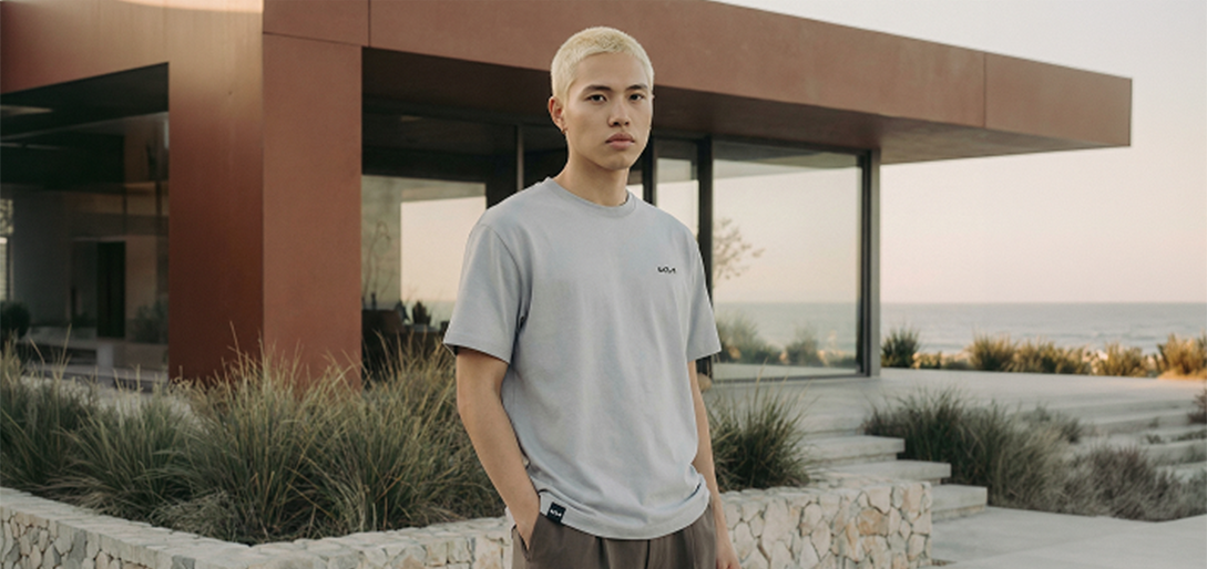 Man standing in front of house wearing Kia T-Shirt