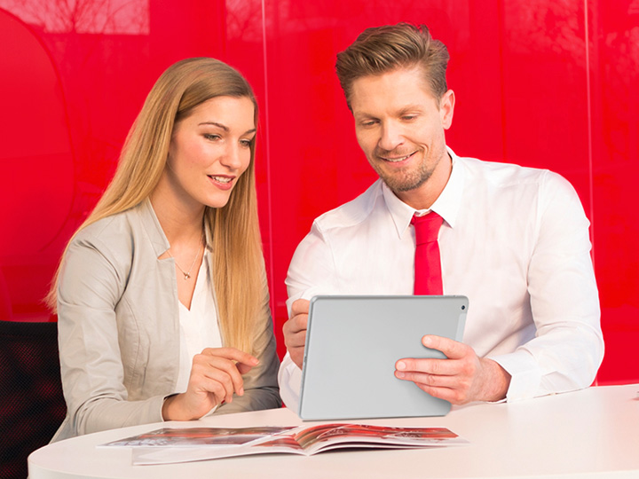 Kia service representative speaking with customer at Kia dealership