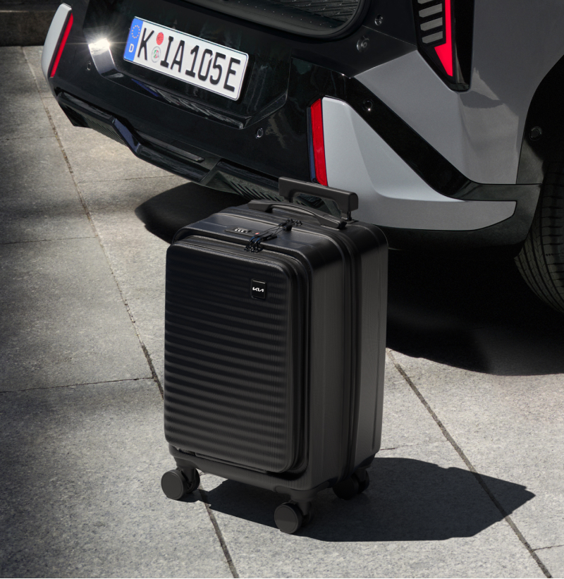 Customer walking with Kia Cabin Luggage during a trip.