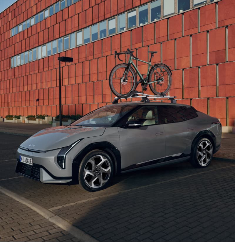 Kia EV4 equipped with the Kia Roof Rack and the Kia Bike Carrier Plus.
