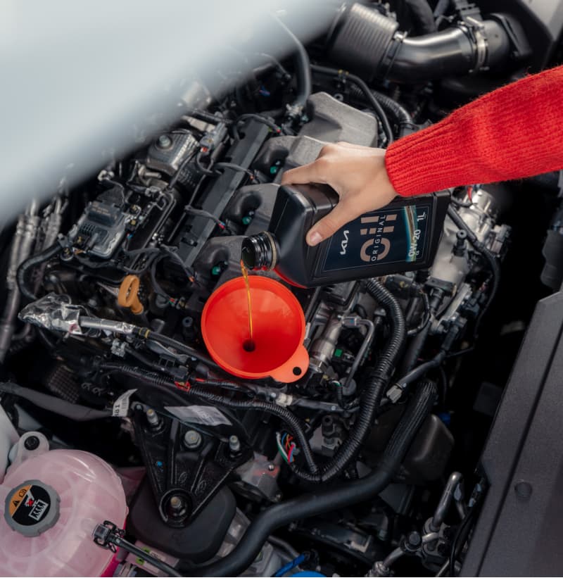 Kia Techniker prüft den Kühlmittelstand im Rahmen des Kia EV Fahrzeug-Checks.
