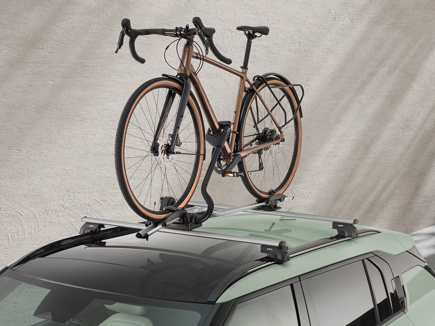 A bicycle secured on the roof rack of a Kia EV3.