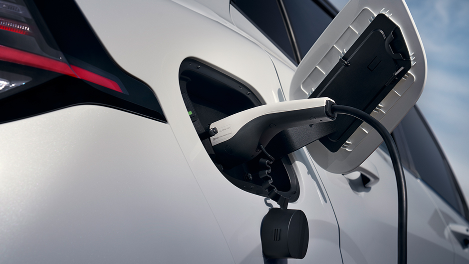 A close up of the Kia GT-Line S EV6 in White Pearl being charged, using a Kia charging cable.