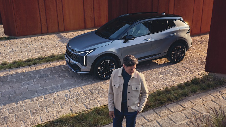 Kia niro EV charging with model sitting on car