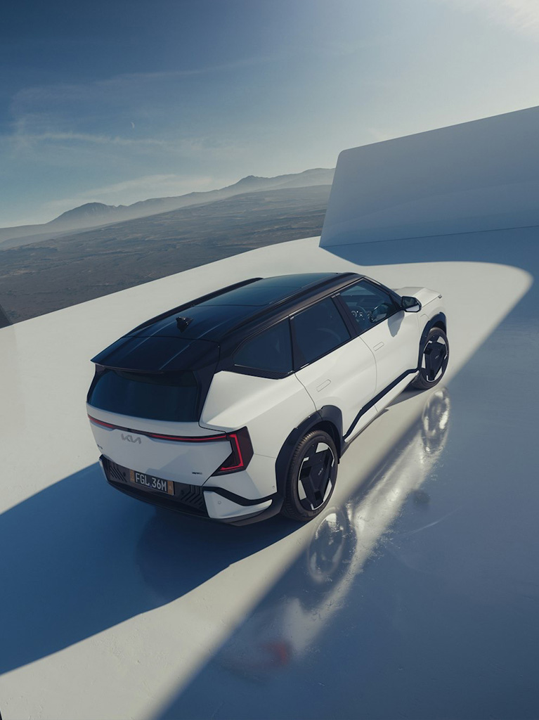 A Kia EV3 on a concrete platform near a lake