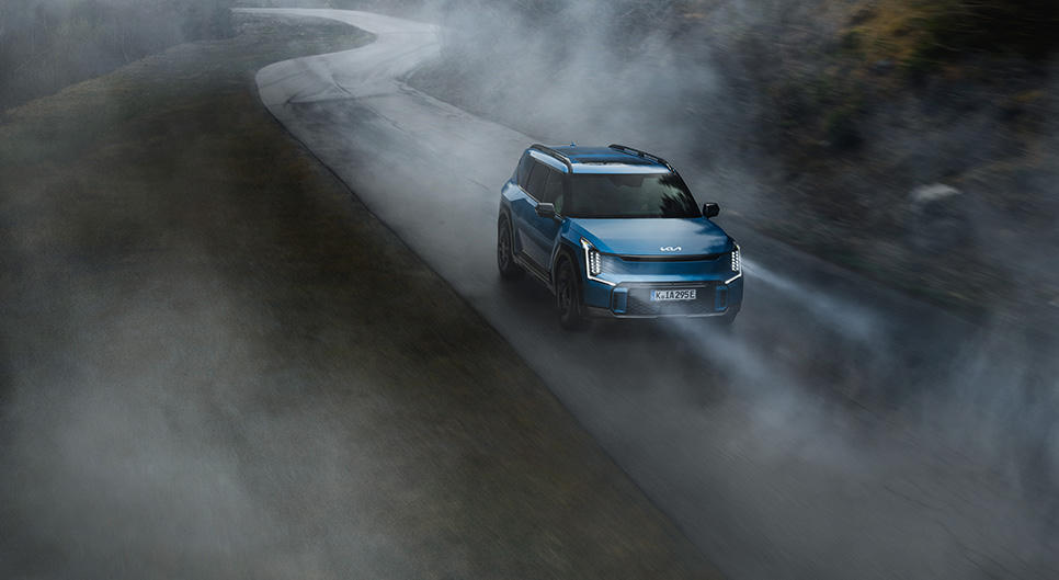 Kia EV9 driving in foggy weather.