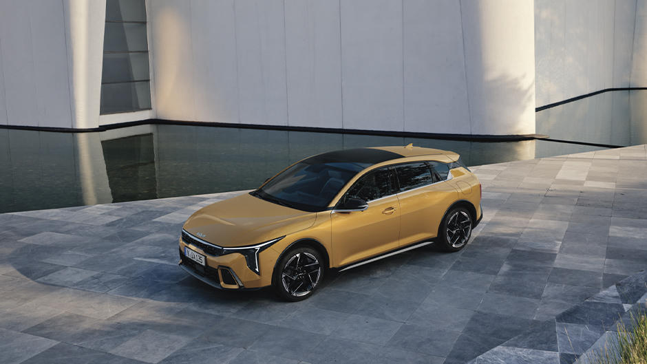 The Kia K4 parked by a building